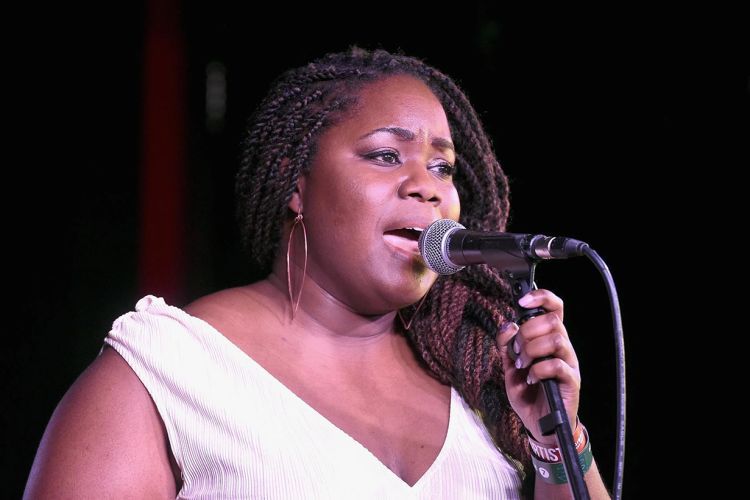 Zara McFarlane singing and holding a microphone